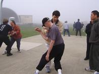 World Tai Chi & Qigong Day; Shorefront Park, Patchogue NY (April 28, 2007): Sifu Tyrone Wei Wicksman, Zhang Style Tai Chi Chuan (in tan jacket), playing with Water Tiger student Michael Kandel during the martial applications portion of his Zhang-Style Tai Chi workshop.