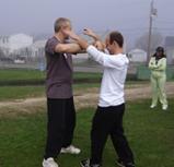 World Tai Chi & Qigong Day; Shorefront Park, Patchogue NY (April 28, 2007): Laoshi Laurince McElroy (L), with Si-Hing Joel Valerio, demonstrates a martial application from the Water Tiger lineages Open Form moment during his workshop on Tai Chi Openings and Closings.