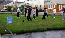 World Tai Chi & Qigong Day; Shorefront Park, Patchogue NY (April 26, 2008): With wind catching their wings, participants follow Laoshi Laurince McElroy (L) during his workshop on the Water Tiger favorite Tai Chi Flying.