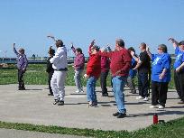 World Tai Chi & Qigong Day; Shorefront Park, Patchogue NY (April 24, 2010): Making her second appearance at the event, Sharon Infante (L), Music, Movement and More of Mt. Sinai, started her workshop with an AM Qigong set and then led participants through aspects of her 24-Posture form.