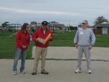 World Tai Chi & Qigong Day; Shorefront Park, Patchogue NY (April 30, 2011): William Hilton (C), Village of Patchogue Trustee, with Maria Hendrickson (L), Director of Parks & Recreation, looking on, presented Event Coordinator Laoshi Laurince McElroy (R), of Water Tiger School of Tai Chi Chuan in Patchogue, with a Proclamation from the Honorable Paul V. Pontieri, Jr., Mayor of Patchogue, and the Village Board of Trustees.