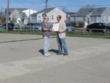 World Tai Chi & Qigong Day; Shorefront Park, Patchogue NY (April 27, 2013): Robert Calarco, Suffolk County Legislature  7th District (L) presents Event Coordinator Laurince McElroy, of Water Tiger School of Tai Chi Chuan in Patchogue (R) a proclamation from the Suffolk County Legislature. The proclamation acknowledges the health benefits of the Chinese arts, as well as the legislatures respect for those that have committed themselves to the spiritual growth and well-being of their fellow citizens. During his presentation, Legislature Calarco spoke to how the arts of Tai Chi and Qigong are unique in their blending of improving wellness with deepening spirituality.