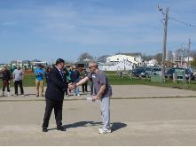World Tai Chi & Qigong Day; Shorefront Park, Patchogue NY (April 27, 2013): Edward P. Romaine, Town of Brookhaven Supervisor (L), presents Event Coordinator Laurince McElroy, of Water Tiger School of Tai Chi Chuan in Patchogue (R), with both a letter-of-support from the Supervisors Office and a proclamation from the Brookhaven Town Council celebrating the events 13th year in the town. During the presentation, Mr. Romaine joked with the attendees about recognizing his own need to take up the arts of Tai Chi and Qigong to help relieve the stress caused by his job.