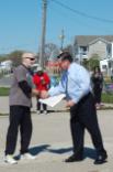 World Tai Chi & Qigong; Shorefront Park, Patchogue NY (April 30, 2016): Edward P. Romaine, Town of Brookhaven Supervisor (R), presents Event Coordinator Laurince McElroy, of Water Tiger School of Tai Chi Chuan in Medford (L), with both a letter-of-support from the Supervisors Office and a proclamation from the Brookhaven Town Council.  The proclamation acknowledges the health benefits of the Chinese arts and recognizes April 30th as World Tai Chi and Qigong Day in the Town of Brookhaven.  During the presentation, Mr. Romaine joked with the attendees about recognizing his own need to take up the arts of Tai Chi and Qigong to help relieve the stress caused by his job.