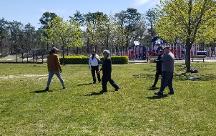 A man overseeing event paricipants as they explore various aspects of empty-hand T'ai Chi Ch'uan.