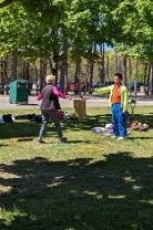 A male facilitator is working with an event participant on a precision drill using a Pilates Magic Circle as a target. 